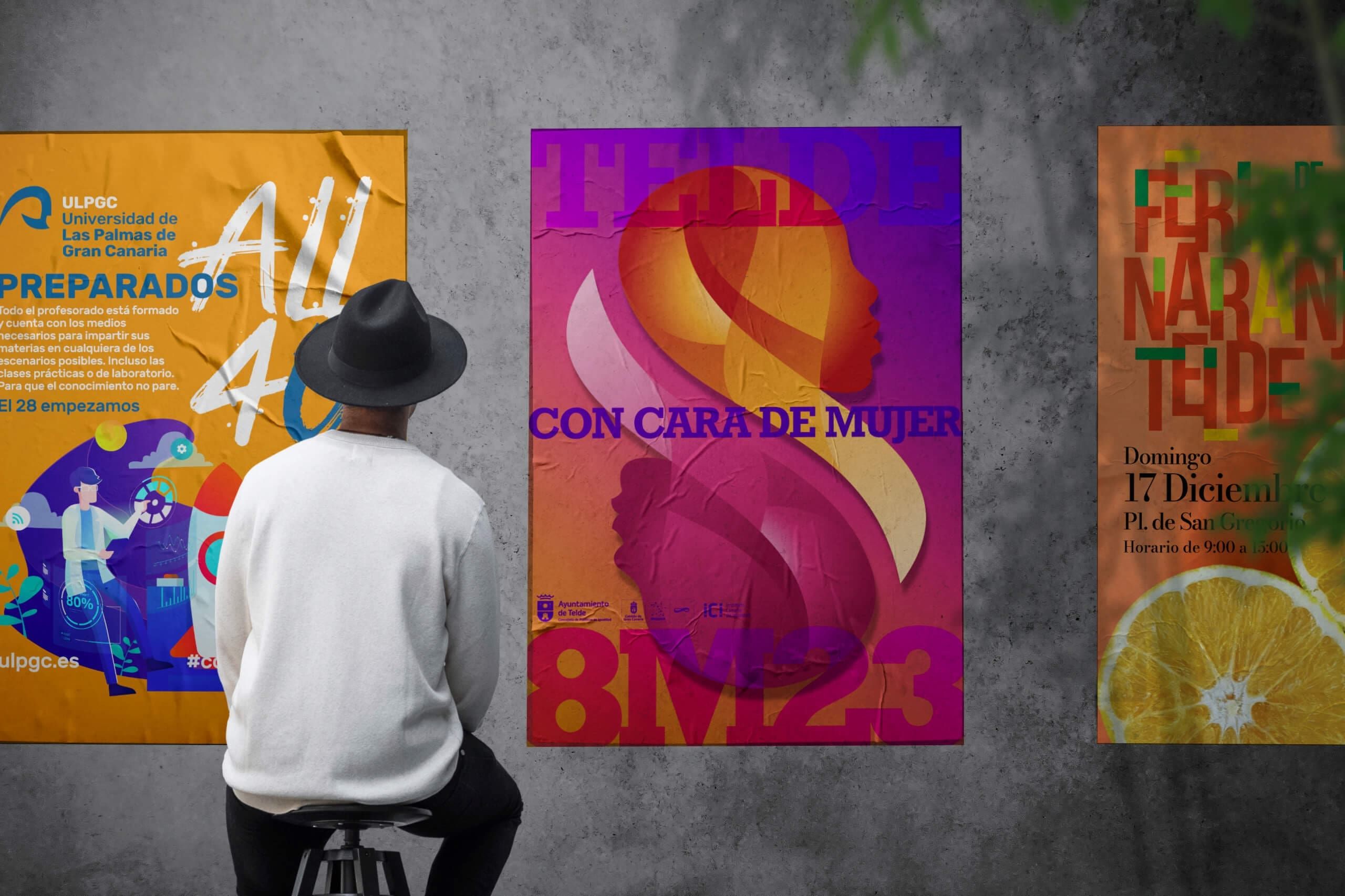 Muro con tres carteles diseñados por nuestro equipo